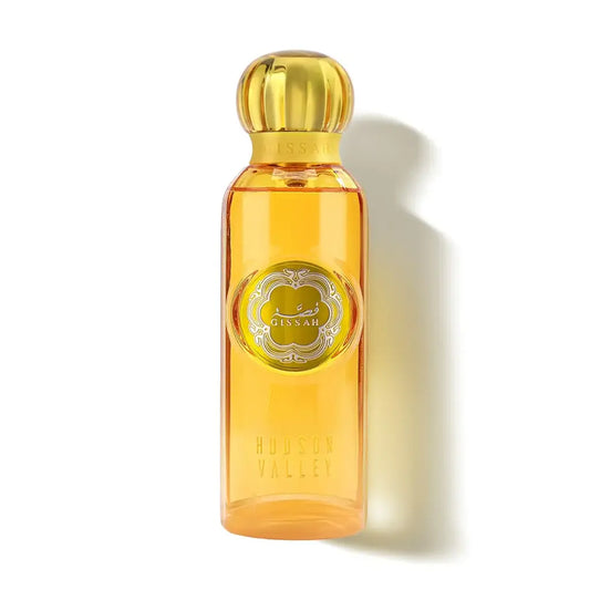 Perfume bottle with gold cap and label on a white background